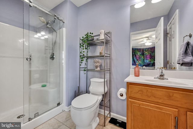 bathroom with vanity, a shower with door, ceiling fan, tile patterned flooring, and toilet