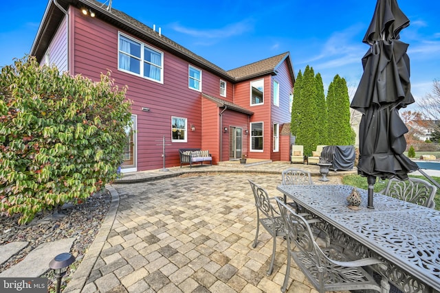 rear view of property featuring a patio