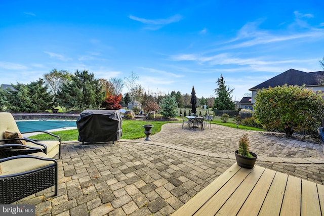 view of patio / terrace featuring a grill and a covered pool