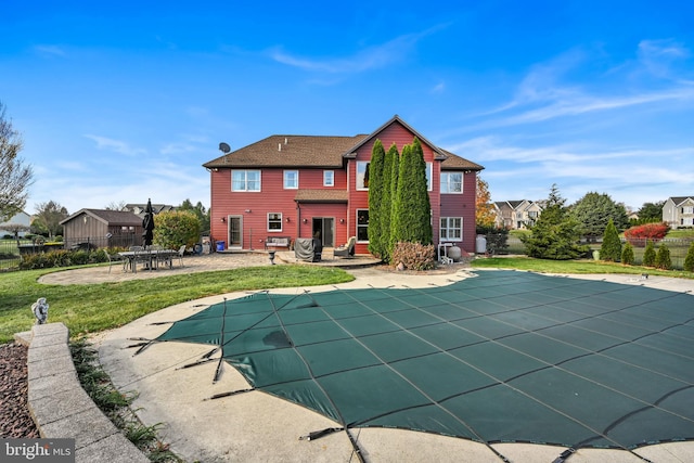 view of pool with a patio area and a yard