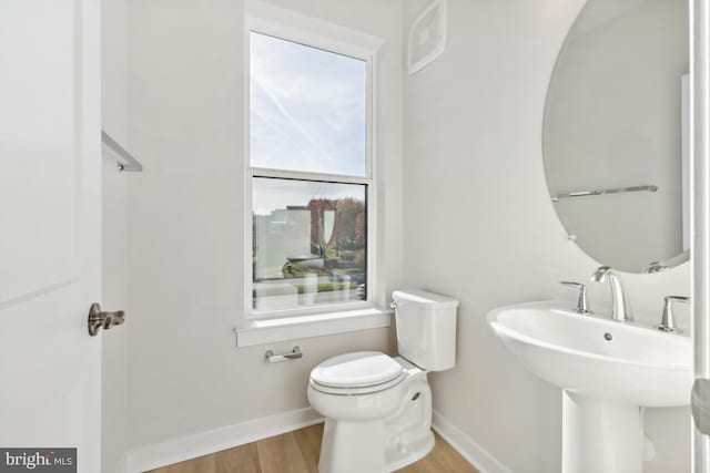 bathroom featuring hardwood / wood-style floors, toilet, and sink