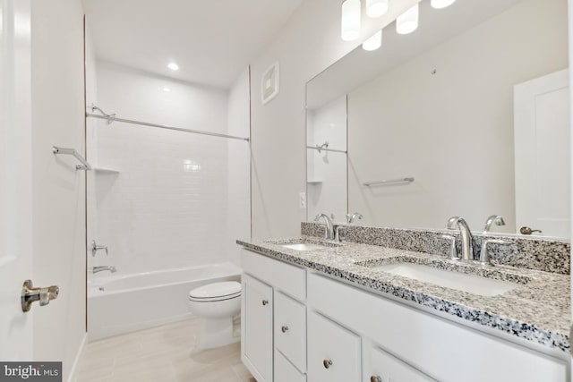 full bathroom with vanity, tiled shower / bath combo, and toilet