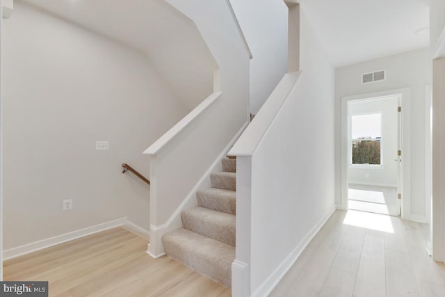 stairs with hardwood / wood-style floors