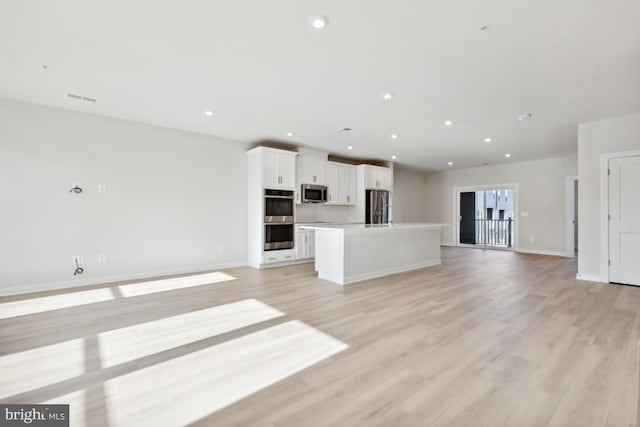 unfurnished living room with light hardwood / wood-style floors