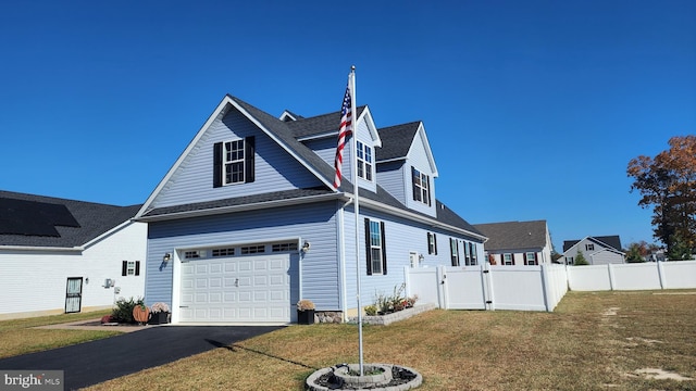 view of front of home with a garage and a front yard