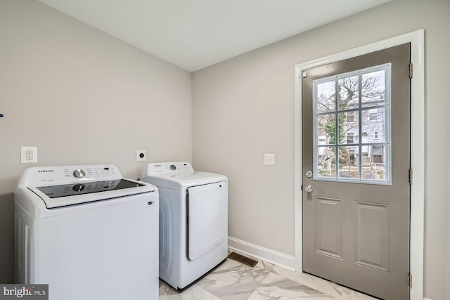 clothes washing area with washing machine and dryer