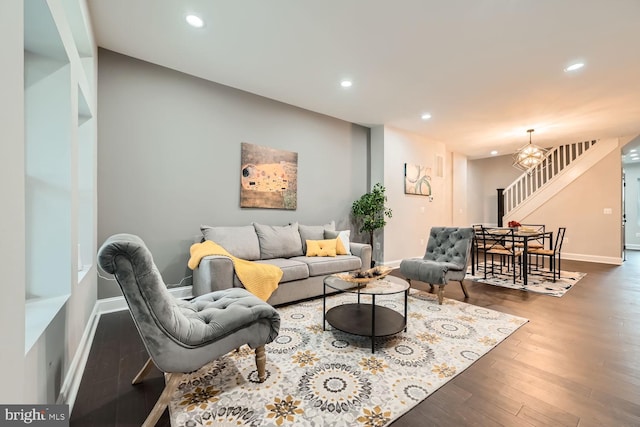 living room featuring dark hardwood / wood-style flooring and a notable chandelier