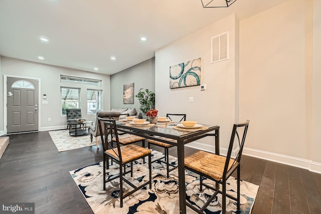 dining area featuring dark wood-type flooring