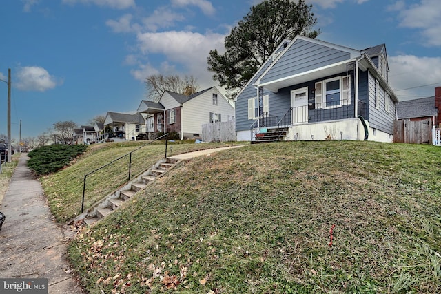 bungalow-style home with a front yard