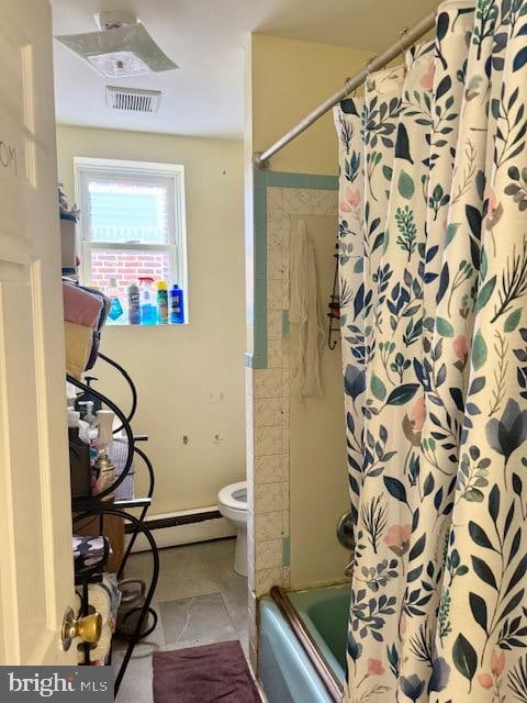 bathroom featuring  shower combination, toilet, and baseboard heating