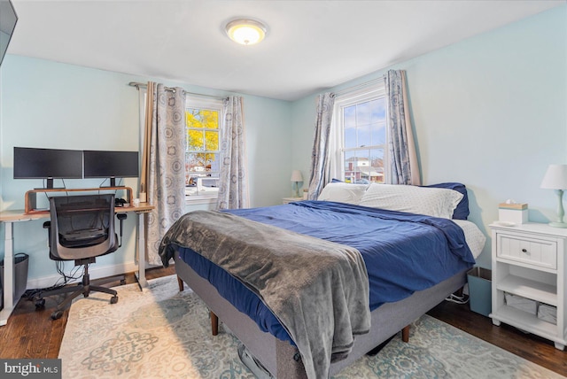 bedroom with dark wood-type flooring