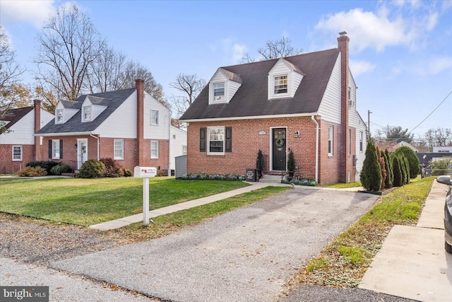 cape cod-style house with a front lawn