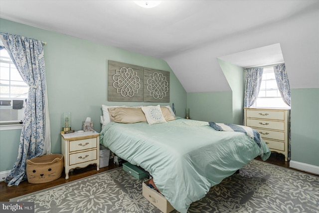 bedroom featuring hardwood / wood-style floors and lofted ceiling