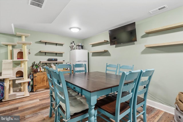 dining room with hardwood / wood-style floors