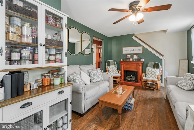 living room with ceiling fan and dark hardwood / wood-style floors