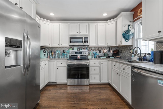 kitchen featuring sink, white cabinets, stainless steel appliances, and dark hardwood / wood-style floors