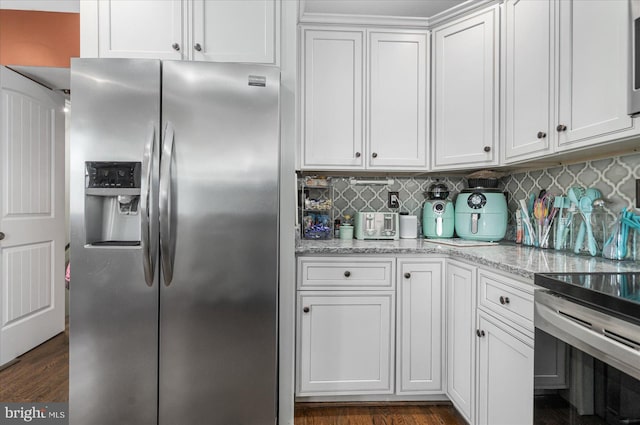 kitchen with white cabinets, light stone counters, dark wood-type flooring, and appliances with stainless steel finishes