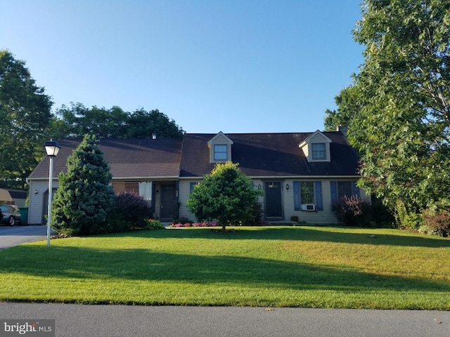 cape cod-style house with a front lawn and a garage