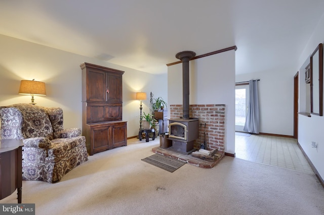 carpeted living room with a wood stove