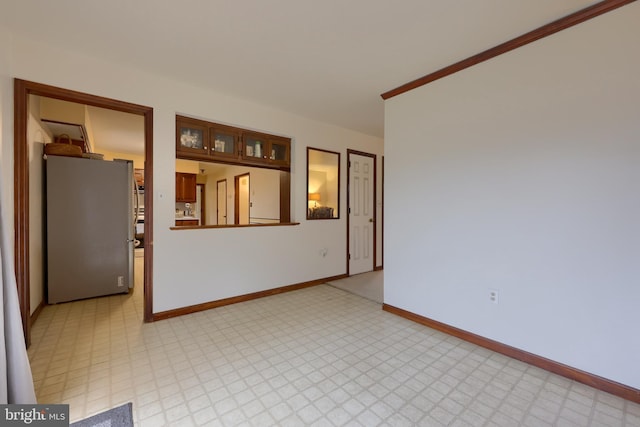 unfurnished room featuring crown molding