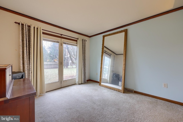 empty room featuring light carpet and crown molding