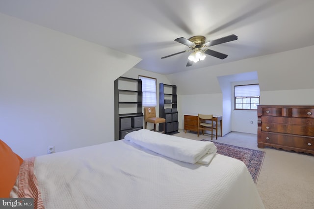 carpeted bedroom featuring ceiling fan and vaulted ceiling