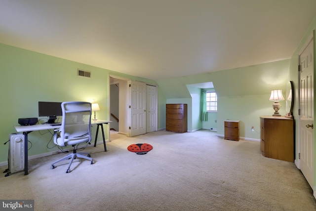 office space featuring light colored carpet and vaulted ceiling