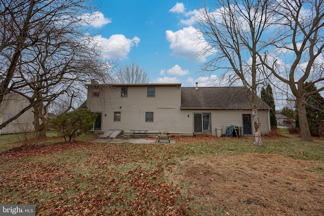 rear view of property with a yard