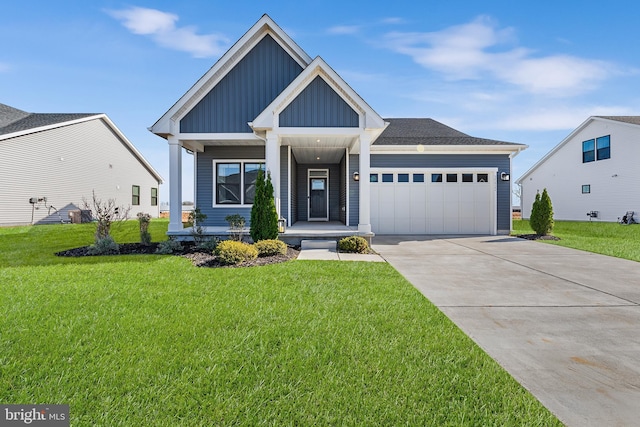 view of front facade featuring a porch, a garage, and a front lawn