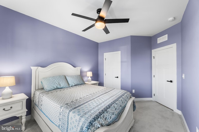 bedroom with ceiling fan and light colored carpet