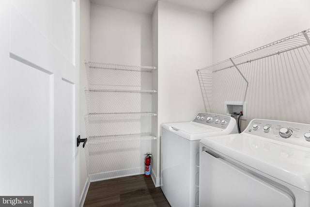 clothes washing area featuring dark hardwood / wood-style flooring and separate washer and dryer