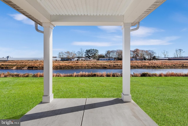 view of patio with a water view