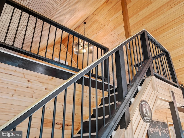 staircase with wooden ceiling and vaulted ceiling