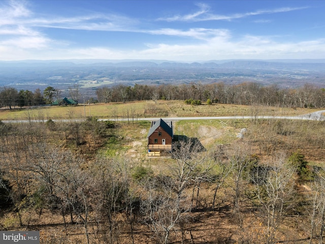 drone / aerial view featuring a mountain view and a rural view