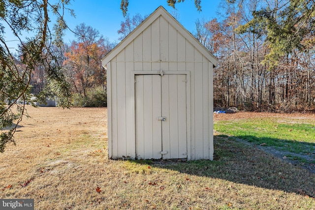 view of outbuilding featuring a lawn