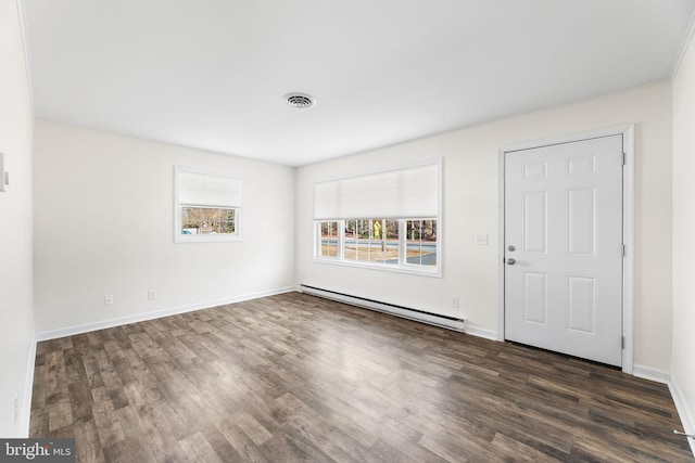 foyer featuring baseboard heating and dark hardwood / wood-style floors