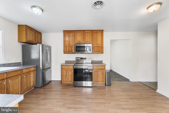 kitchen featuring light wood-type flooring and stainless steel appliances