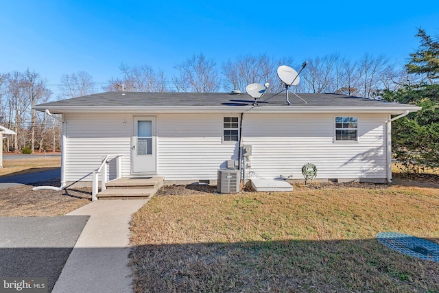 back of property featuring a yard and central AC unit