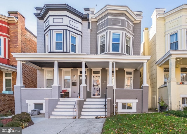 townhome / multi-family property with covered porch