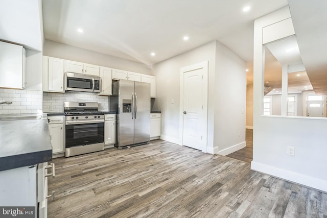 829 Chauncey Ave, Baltimore, MD 21217 - kitchen featuring appliances with stainless steel finishes, a sink, white cabinetry, tasteful backsplash, and light wood-style floors