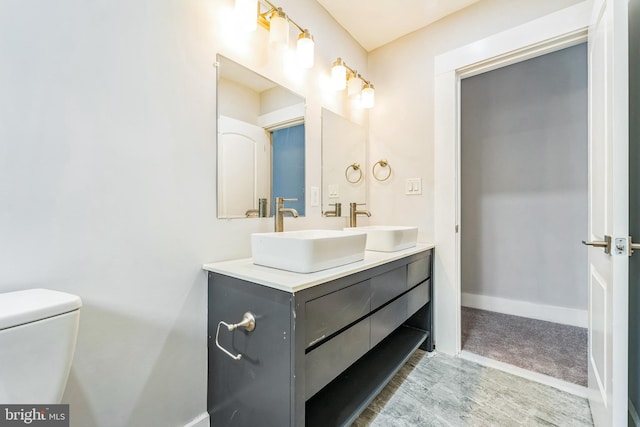 829 Chauncey Ave, Baltimore, MD 21217 - bathroom with double vanity, baseboards, and toilet