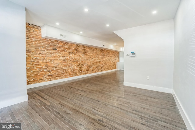 829 Chauncey Ave, Baltimore, MD 21217 - empty room featuring wood finished floors, brick wall, baseboards, and recessed lighting
