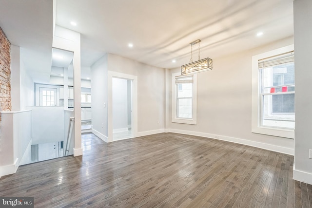 unfurnished dining area with dark hardwood / wood-style floors and a wealth of natural light