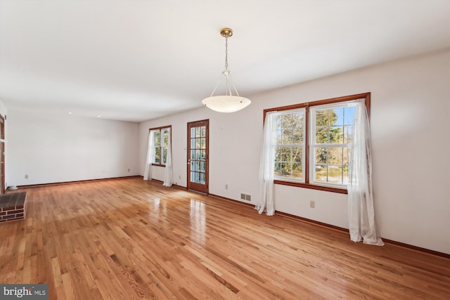 unfurnished dining area with light wood-type flooring