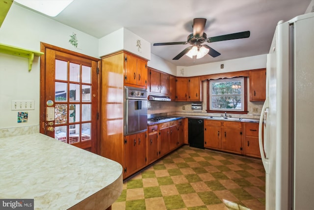 kitchen with ceiling fan, backsplash, appliances with stainless steel finishes, and sink