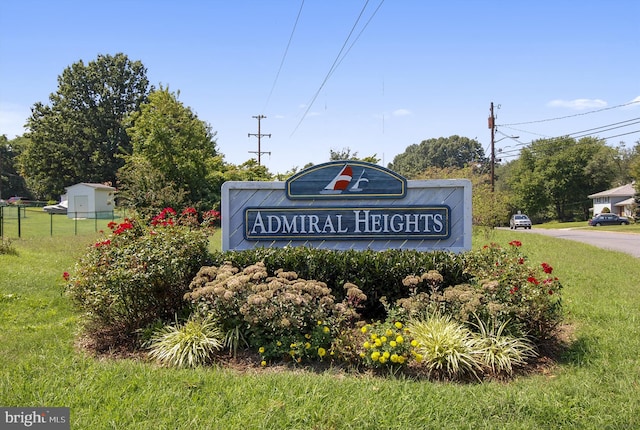 community / neighborhood sign with a lawn