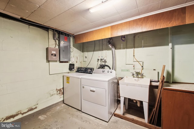 clothes washing area with sink, electric panel, and independent washer and dryer