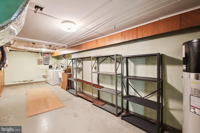 basement featuring water heater and washing machine and dryer