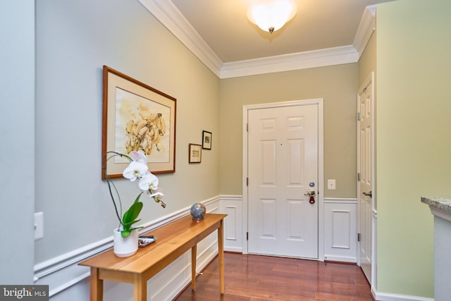 foyer entrance with dark hardwood / wood-style flooring and ornamental molding