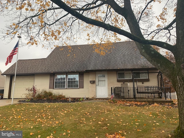 view of front of property featuring a garage and a front lawn